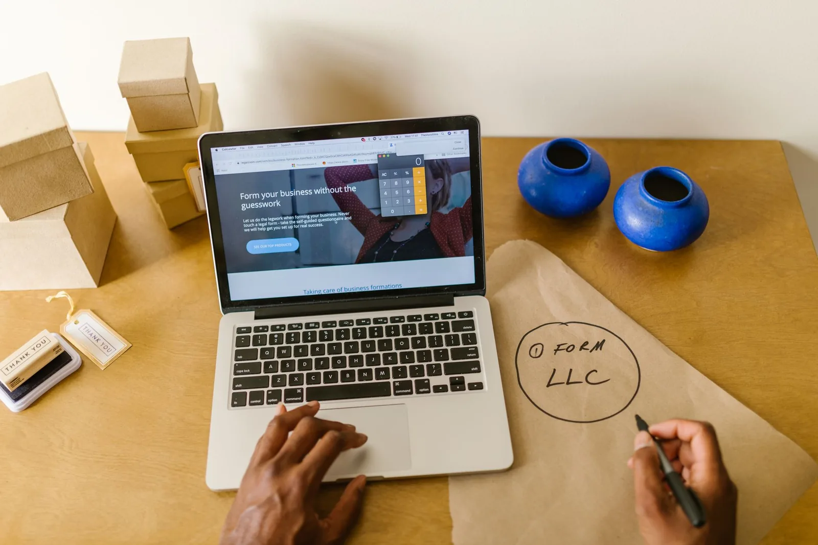 Small business owner reviewing data analytics and AI automation workflows on a laptop in an office