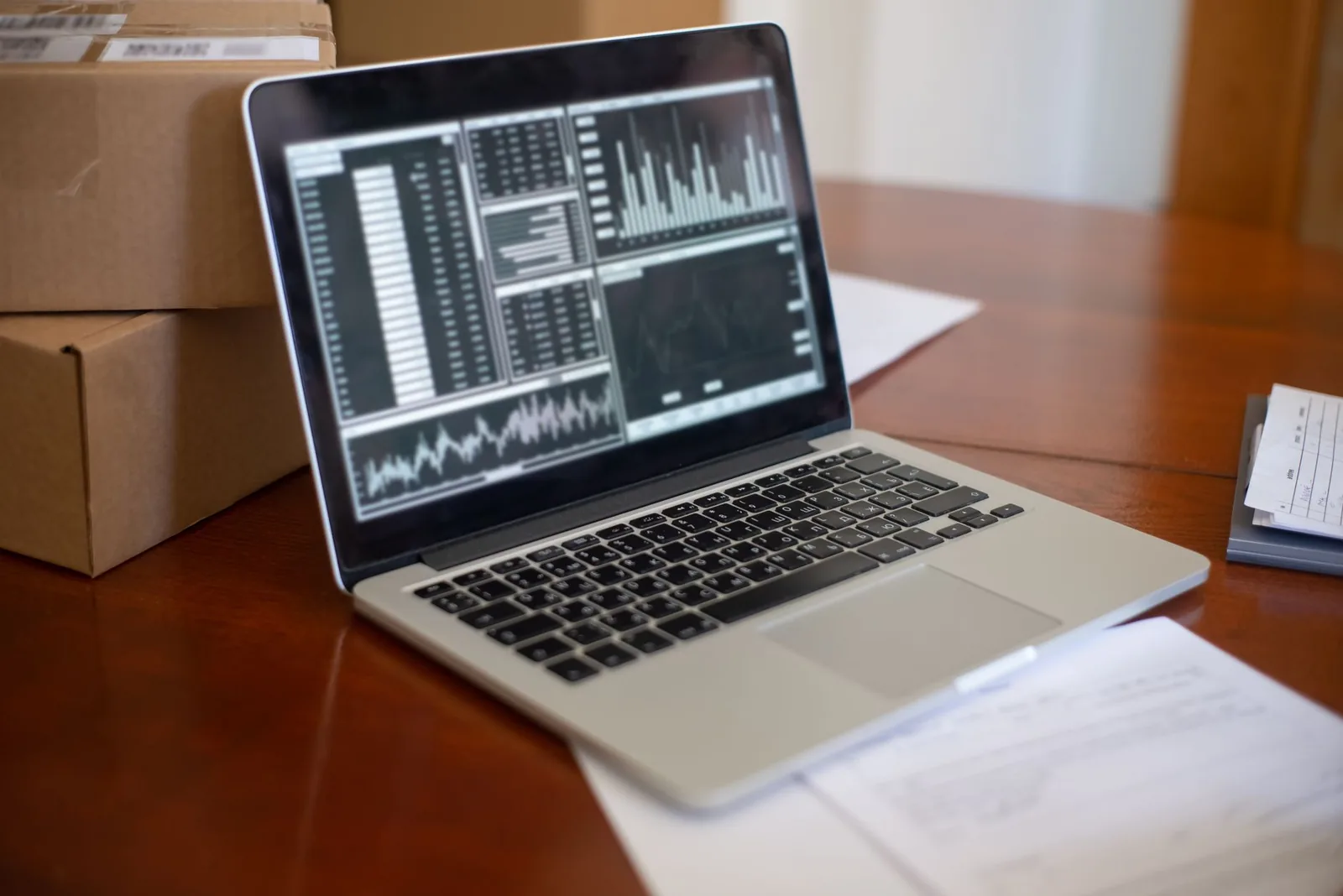 Small business owner working on laptop with automation dashboard, representing SMB AI adoption in the US
