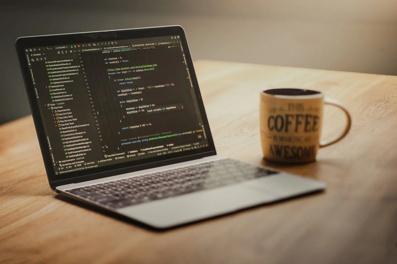 Developer building a business website on a laptop with analytics dashboard and code editor open