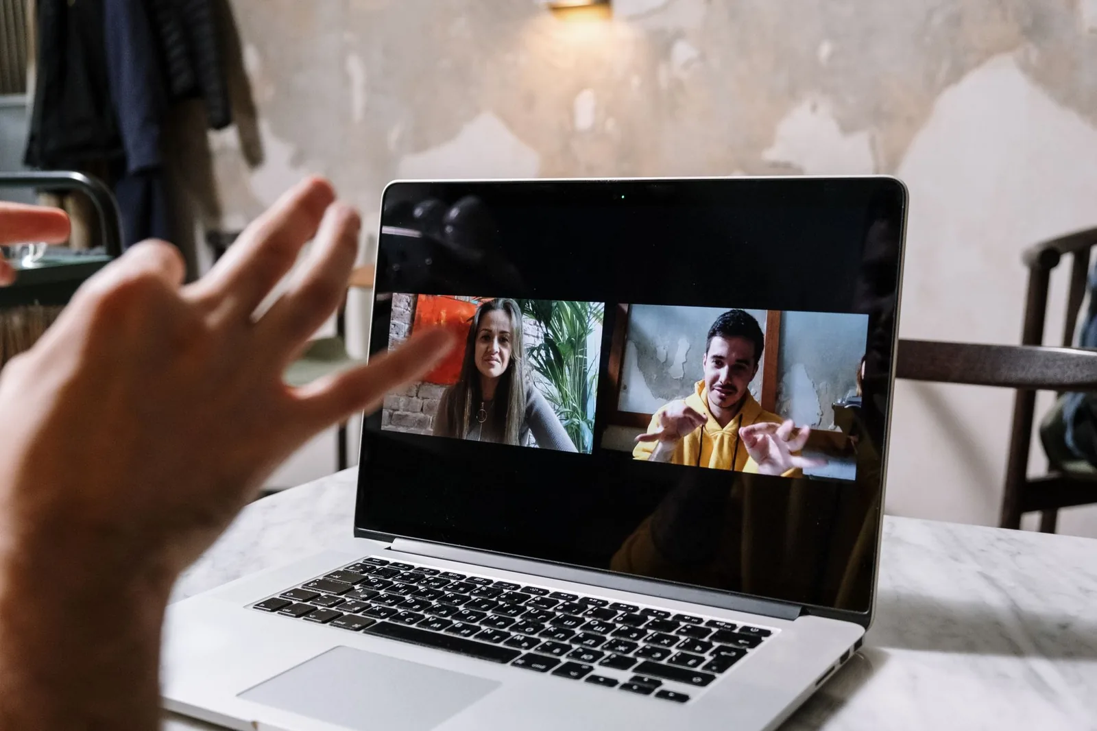 Team members collaborating at laptops in a shared chat workspace, illustrating humans and AI agents working together in Buzz