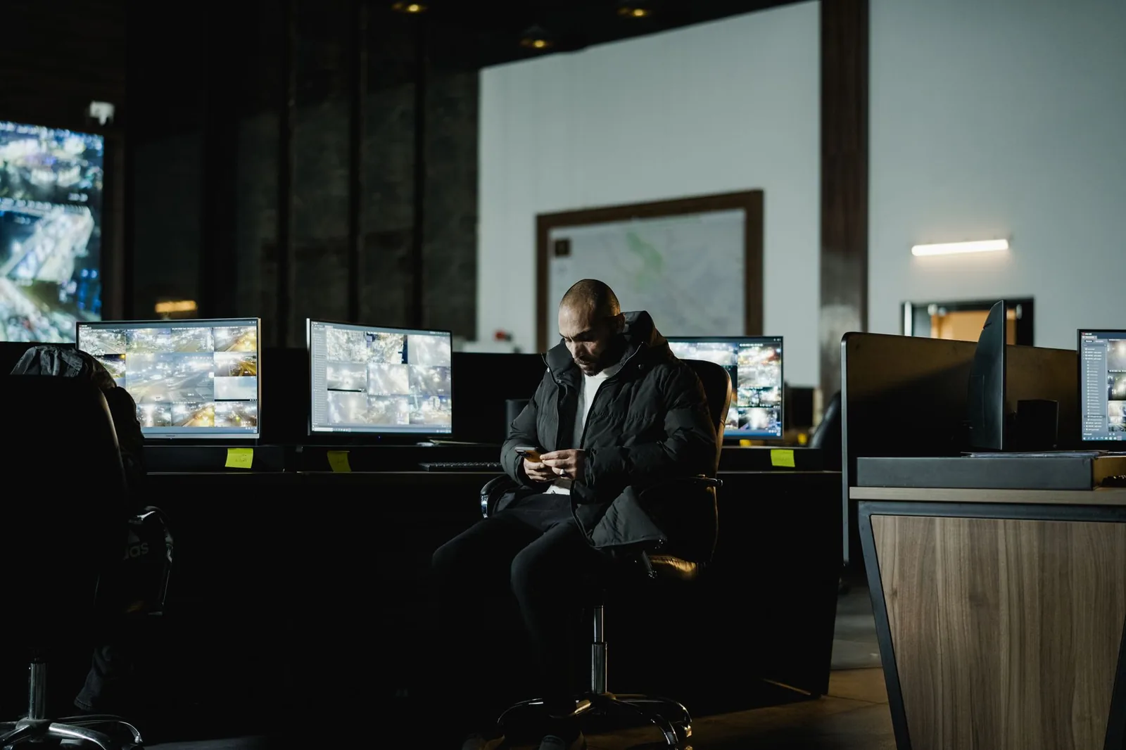 Security analyst monitoring network dashboards on multiple screens to check endpoint coverage before AI agent automation