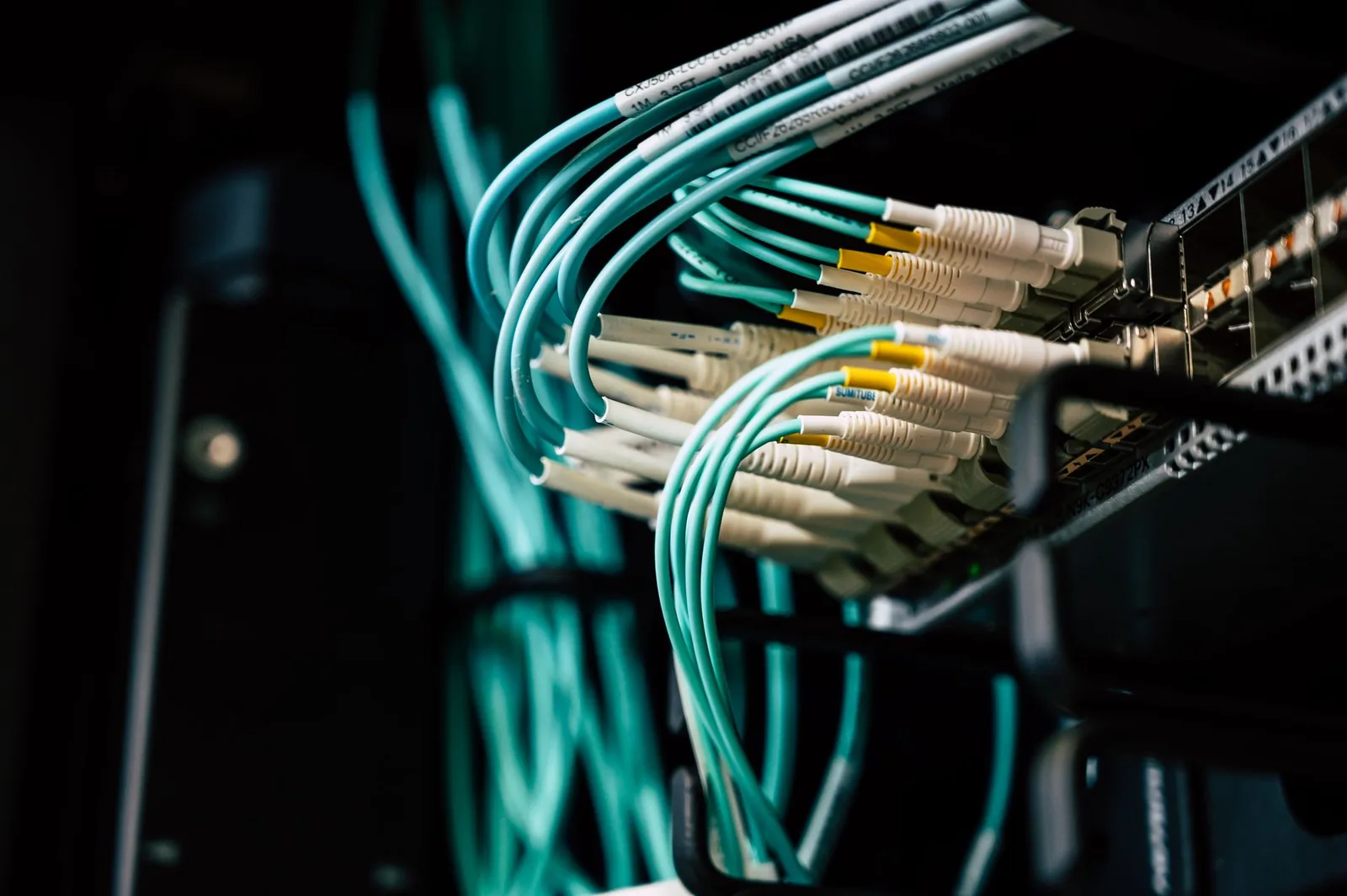 Rows of network servers with cables in a data center, illustrating stateless MCP server deployment