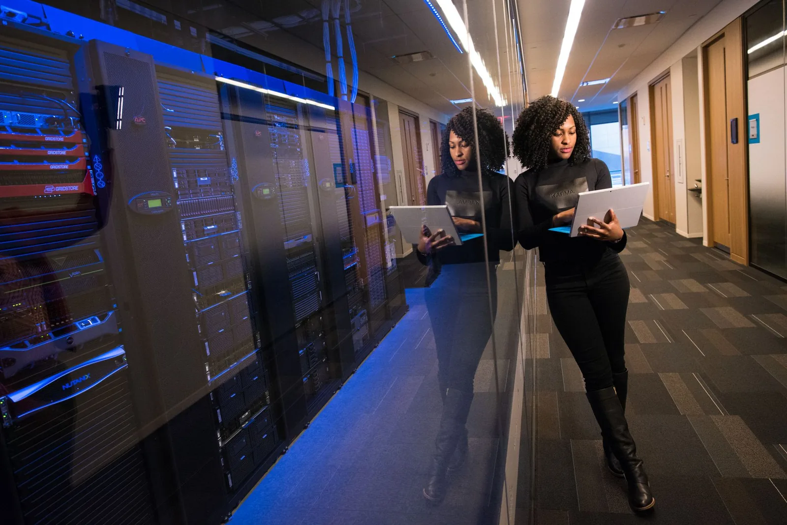 Engineer monitoring AI agent logs and observability dashboards on multiple screens in a production environment