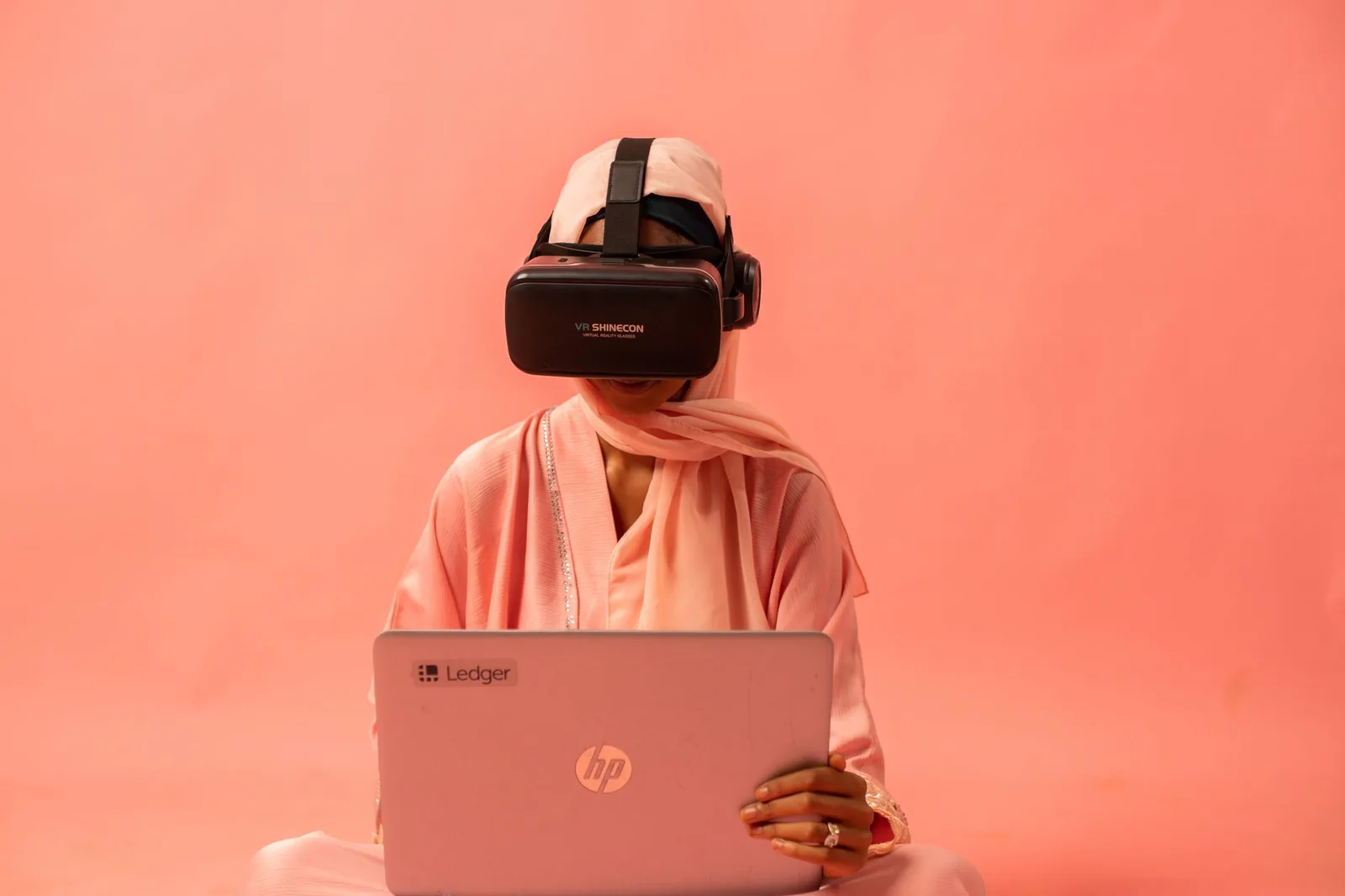 Developer wearing a headset speaking to a laptop with code on screen, illustrating voice control for Codex
