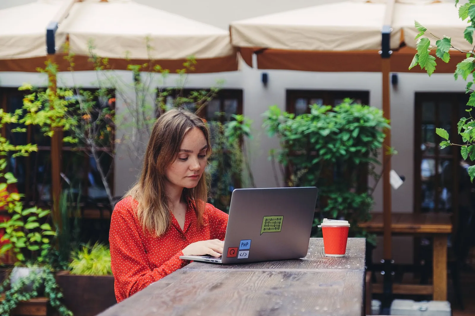 Freelance web developer reviewing a business website mockup on a laptop in a bright workspace