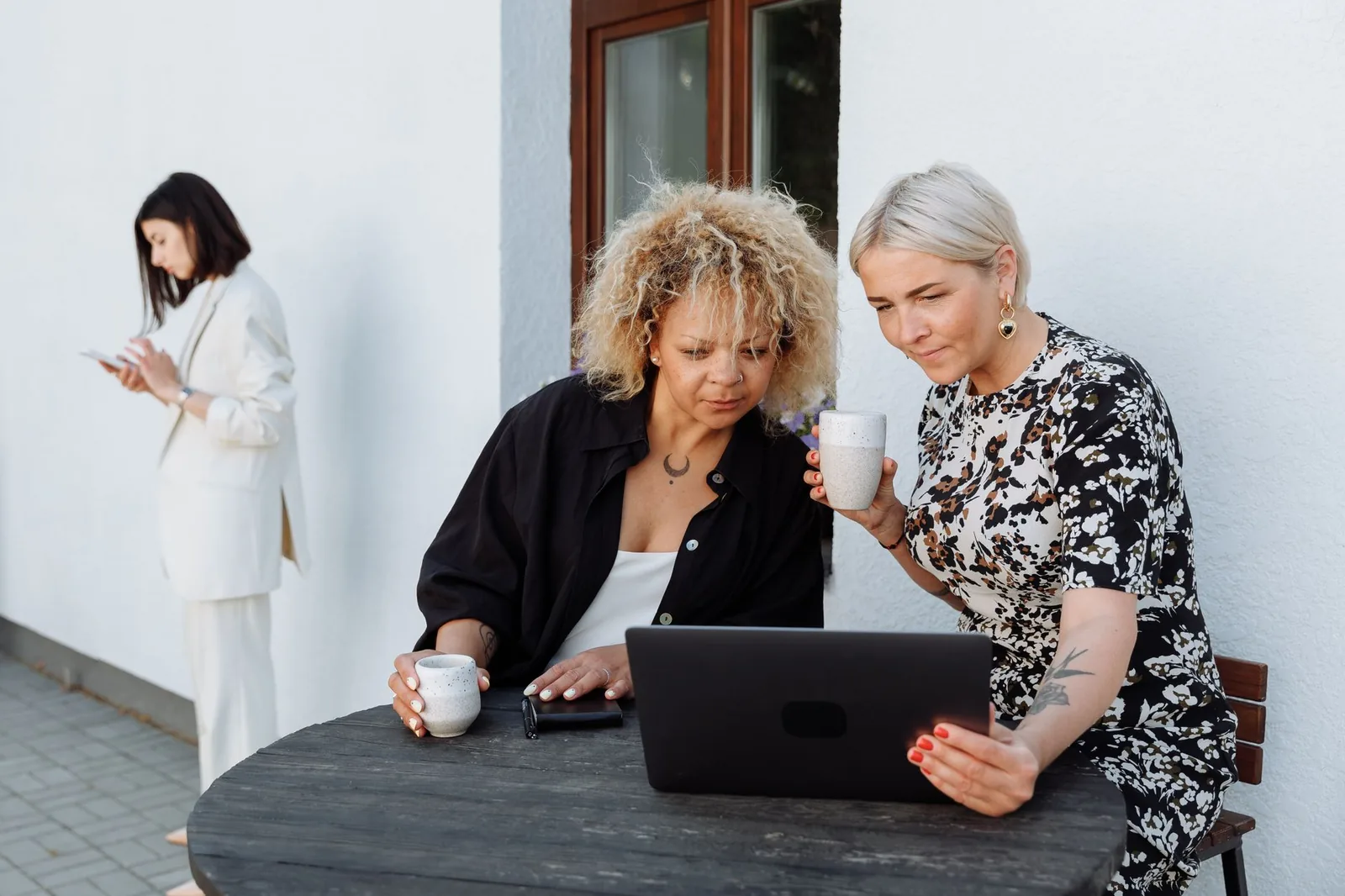 Small business team reviewing workflow automation options on laptops in a modern office