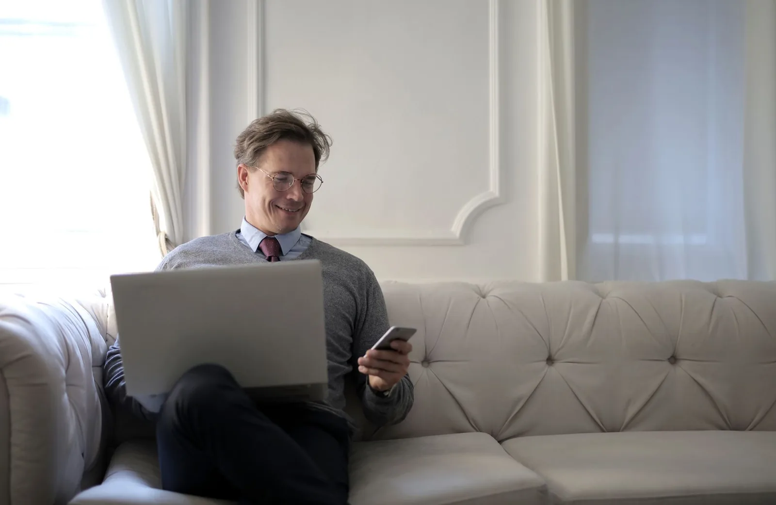 Developer configuring WhatsApp Business API integration on a laptop with a smartphone showing a chat interface