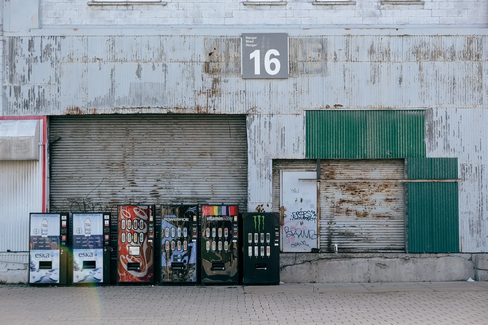 Row of vending machines in a warehouse representing an AI agent running a simulated retail business