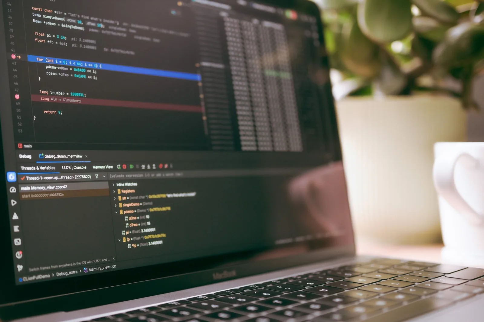 Developer reviewing lines of code on a laptop screen while debugging an AI agent pipeline